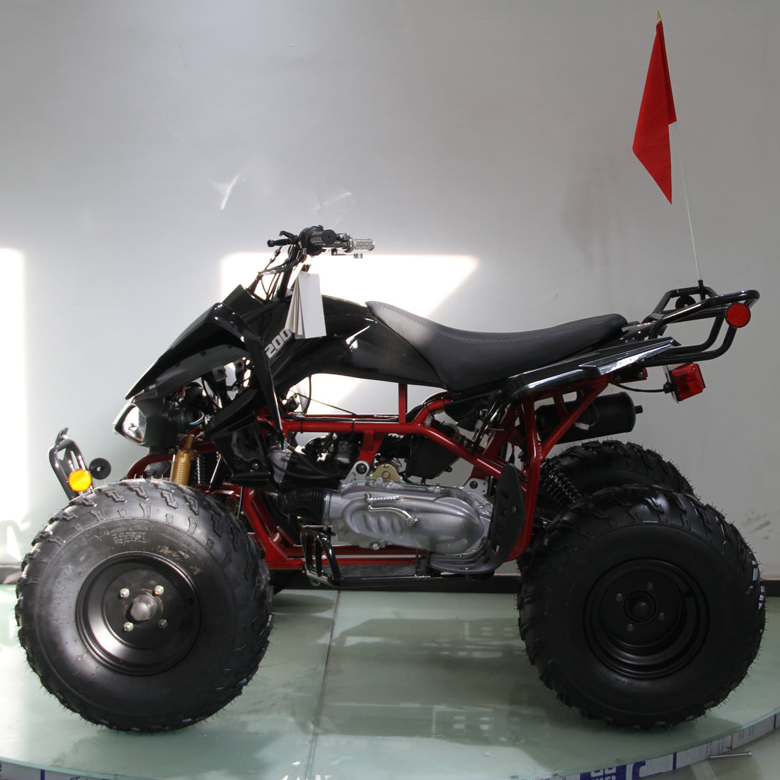 Four-wheeler on a glass surface with a white background
