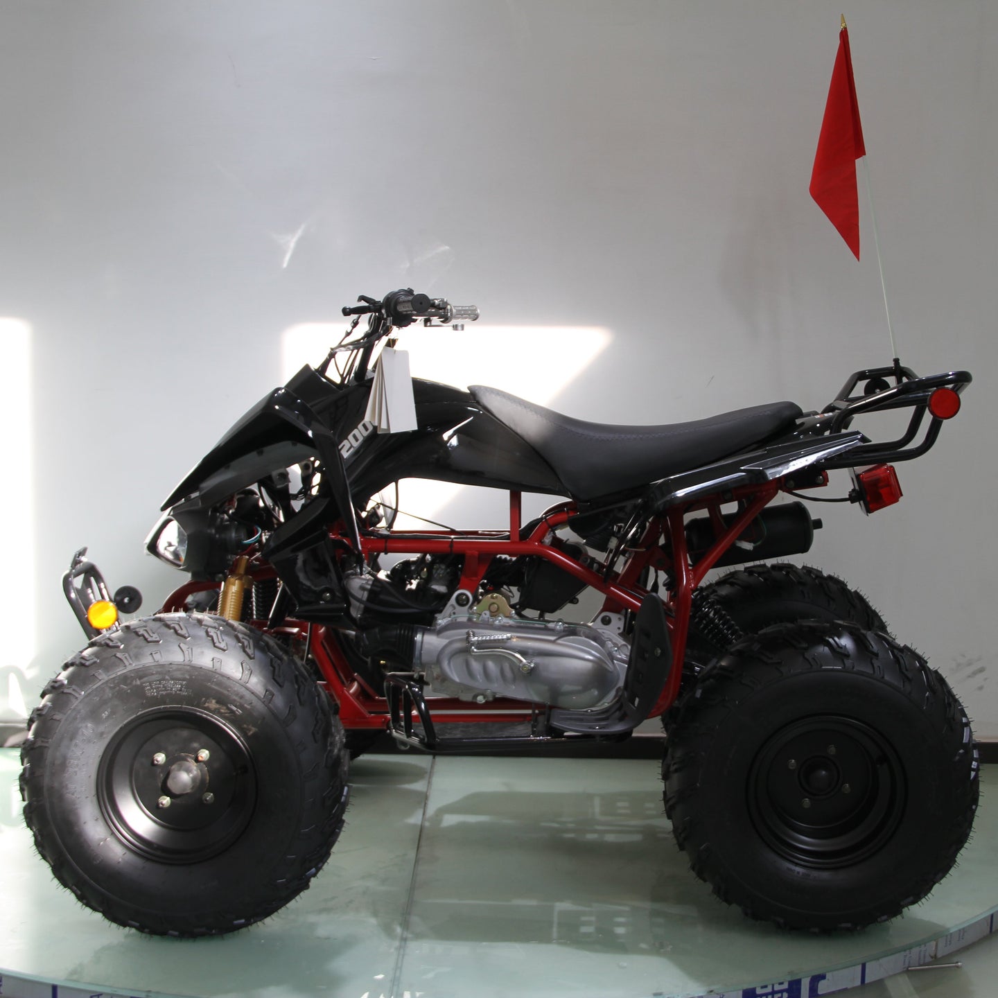 Four-wheeler on a glass surface with a white background